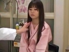 Introvert Oriental In Doctors Office For Breast Check Up